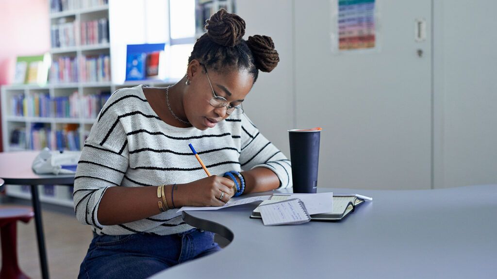 Woman using highly effective study habits at desk