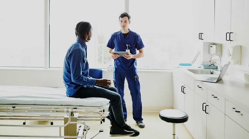 Doctor talking to patient in exam room