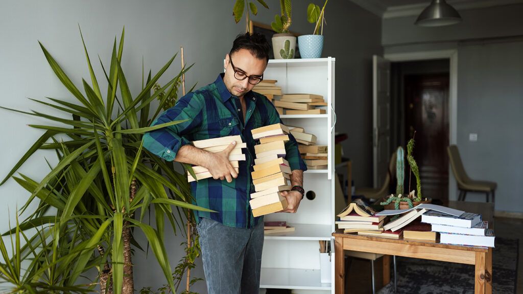 Man organizing books