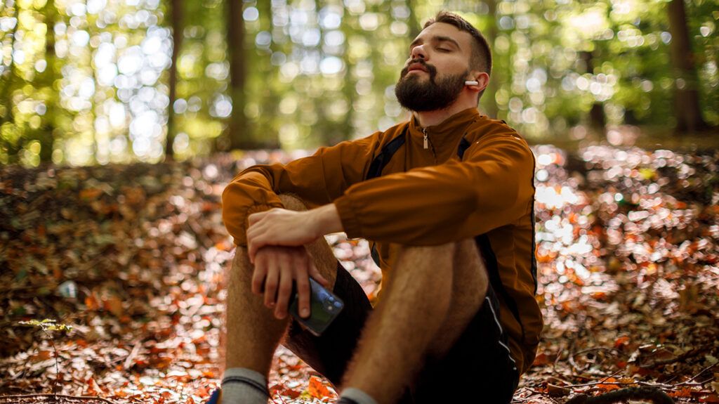 https://media.post.rvohealth.io/wp-content/uploads/sites/4/2021/08/man-sitting-down-woods-nature-headphones-eyes-closed-1296x728-header-1024x575.jpg