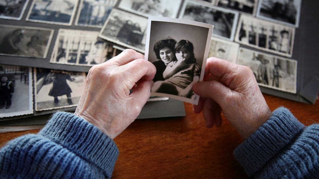 Senior hands holding old photograph