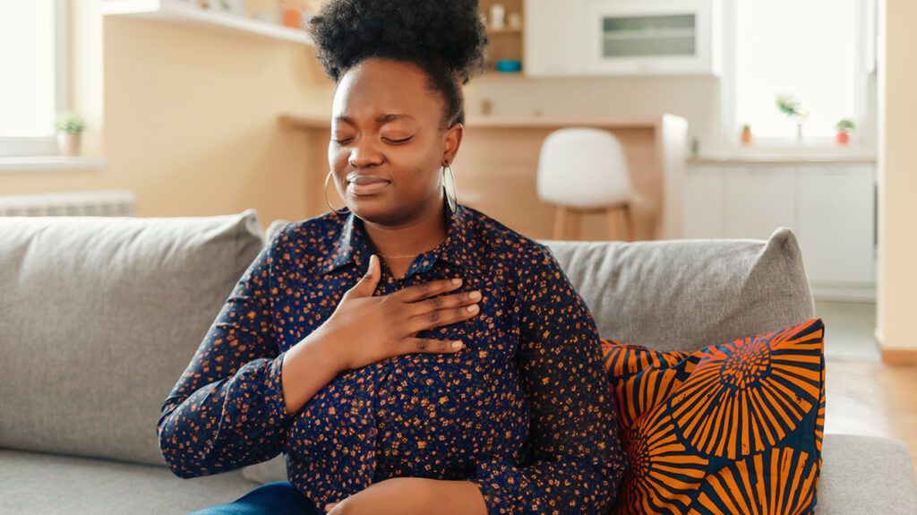 a woman experiencing anxiety chest pain