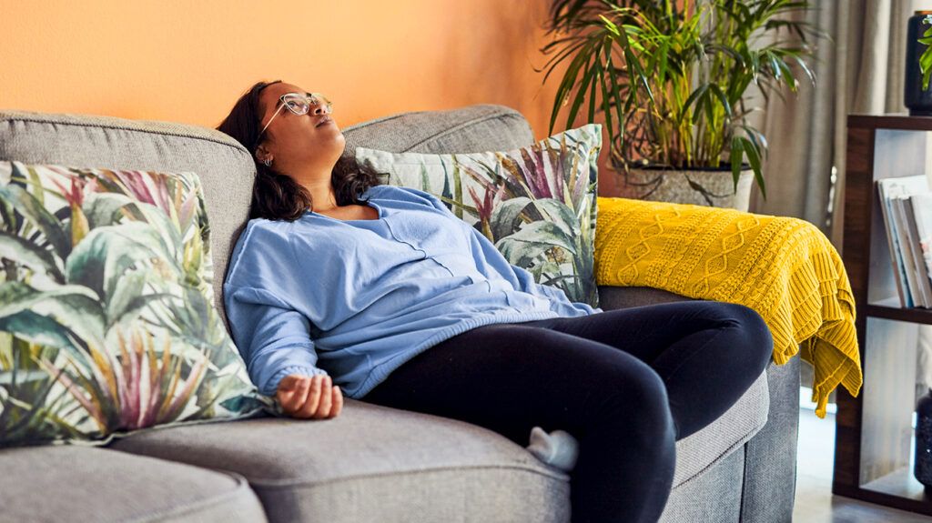 Tired woman resting on couch