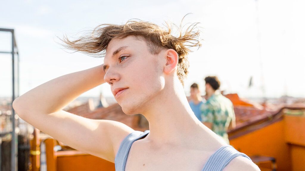 Young contemplative person with hair blowing in wind