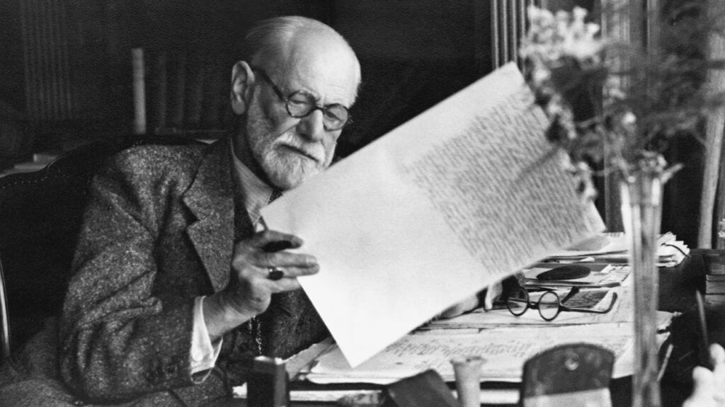Sigmund Freud reading at desk
