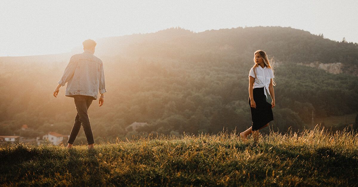 Couple standing face to face with their eyes closed. Boyfriend and  girlfriend imagine their future together.