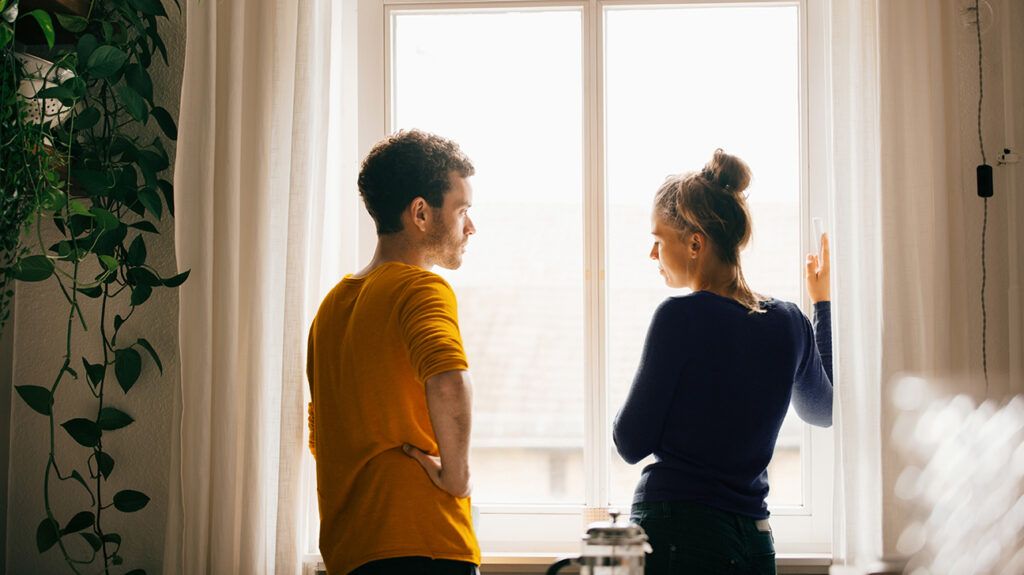 Couple talking by a window