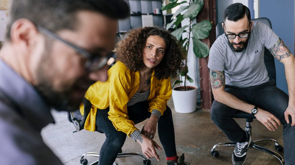 Women staring in awe at coworker who made a rude comment, taking a mindful pause before replying