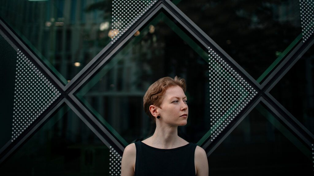 Redheaded woman against window