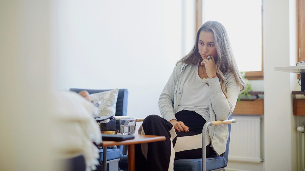 Young woman sitting in therapy