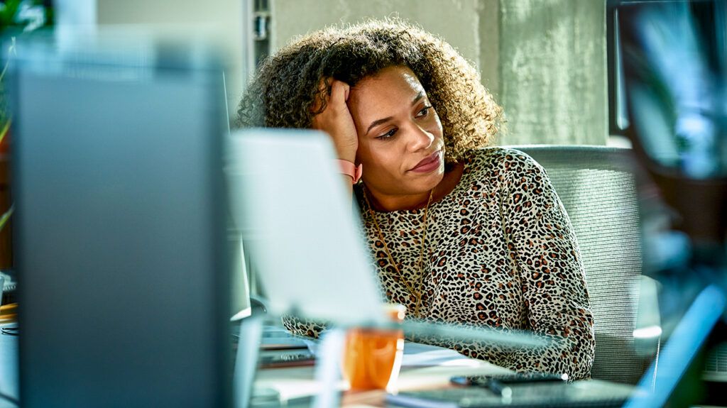 Woman at her desk experiencing burnout