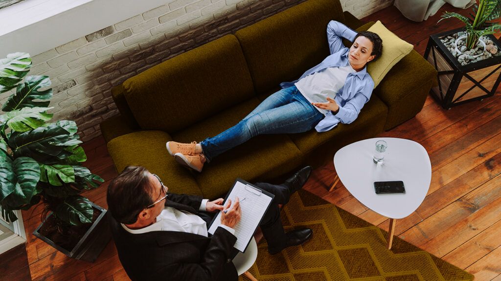 Woman lying down on couch during therapy session