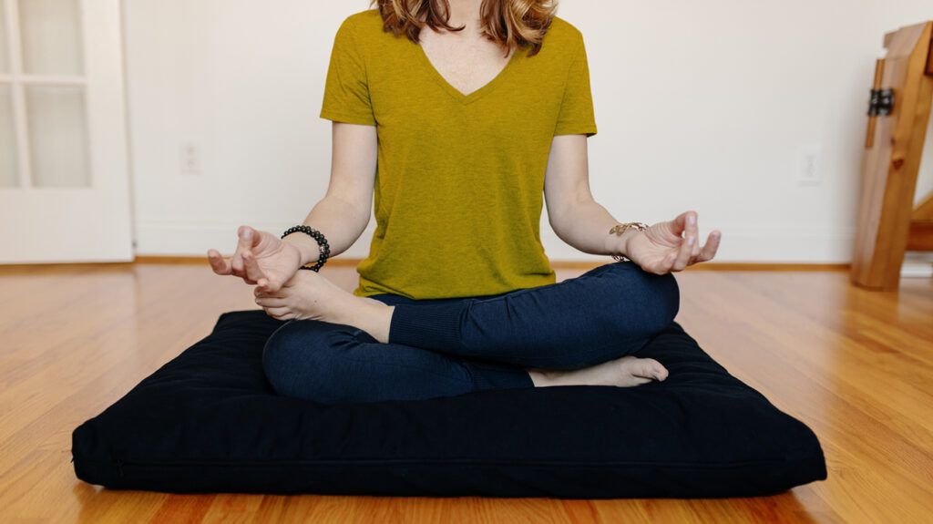 https://media.post.rvohealth.io/wp-content/uploads/sites/4/2021/10/cropped-woman-sitting-cross-legged-meditating-pillow-1296x728-header-1024x575.jpg