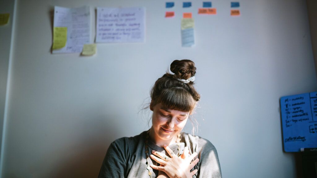 Woman with her hand on her heart