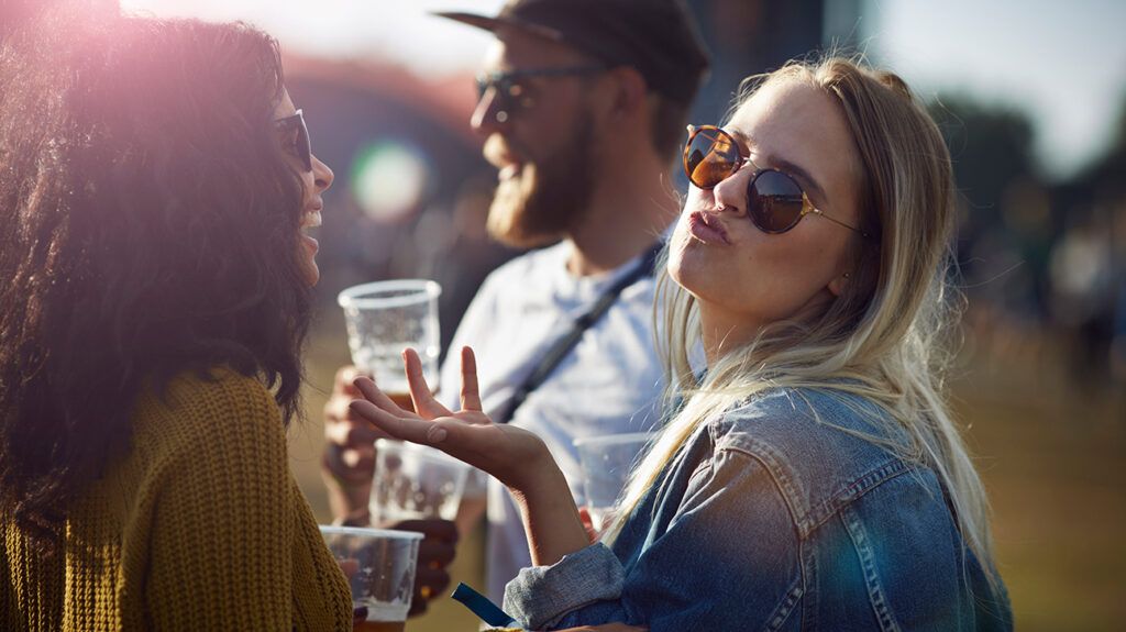 One friend smiles at the other, recognizing narcissist traits