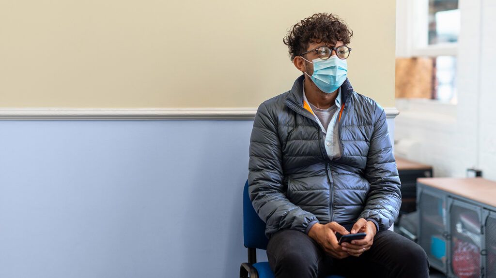 Man in mask in waiting room