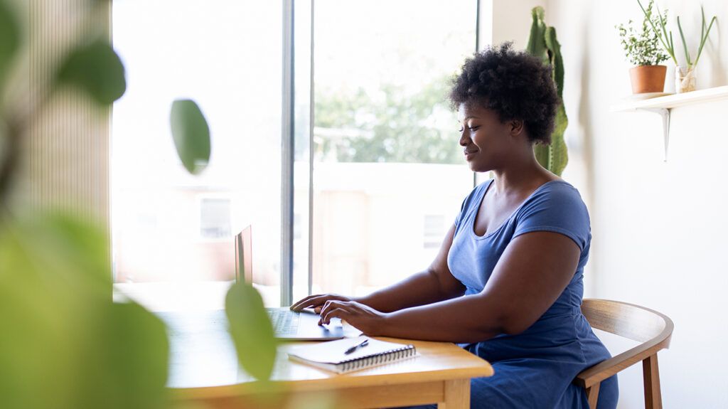 Woman looking for online resources for depression on her laptop