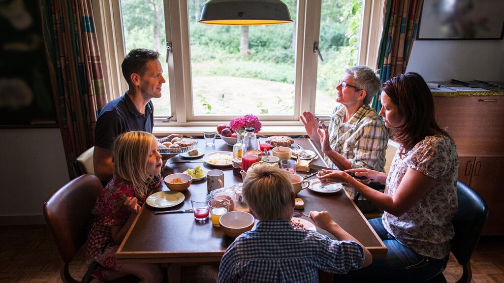 Multigenerational family eating together at the kitchen table