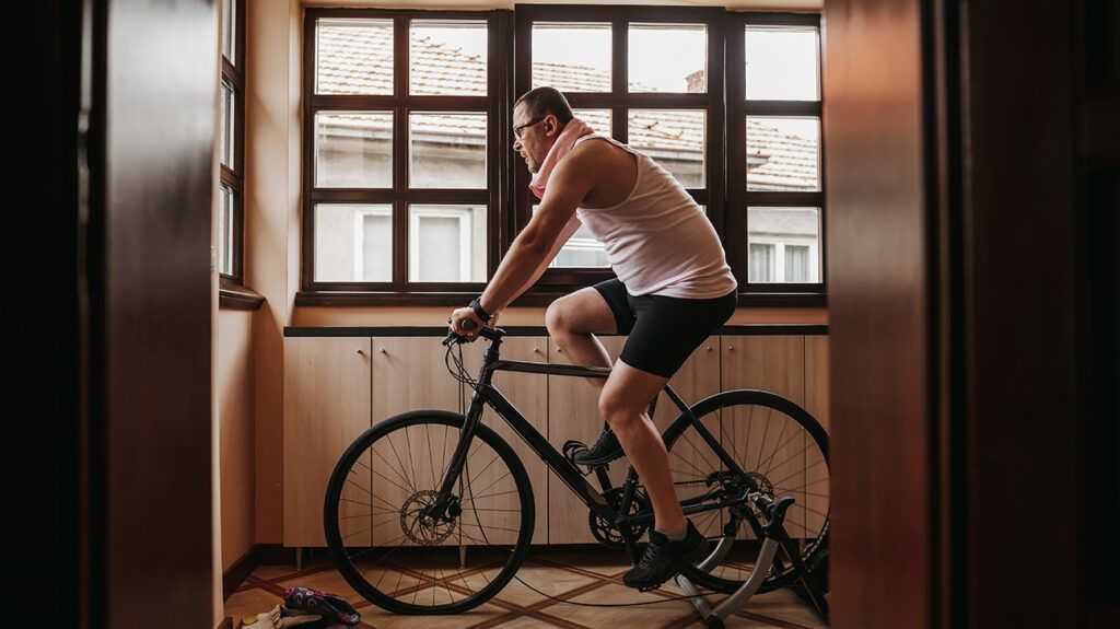 Man riding his stationary bike, verbally chastising himself, a form of self-abuse