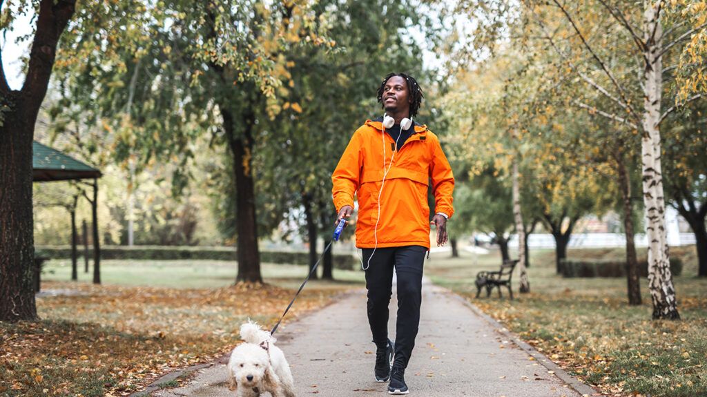 Man walking his dog to help overcome his migraine