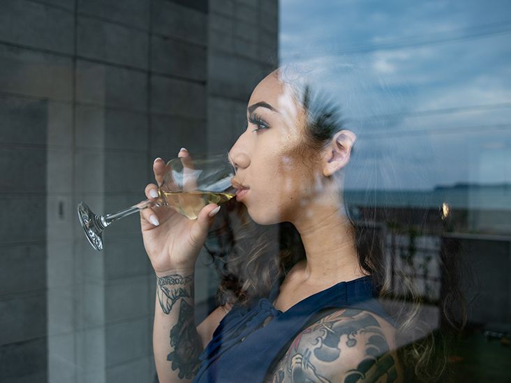 https://media.post.rvohealth.io/wp-content/uploads/sites/4/2021/12/woman-drinking-wine-window-reflection-tattoos-732x549-thumbnail.jpg