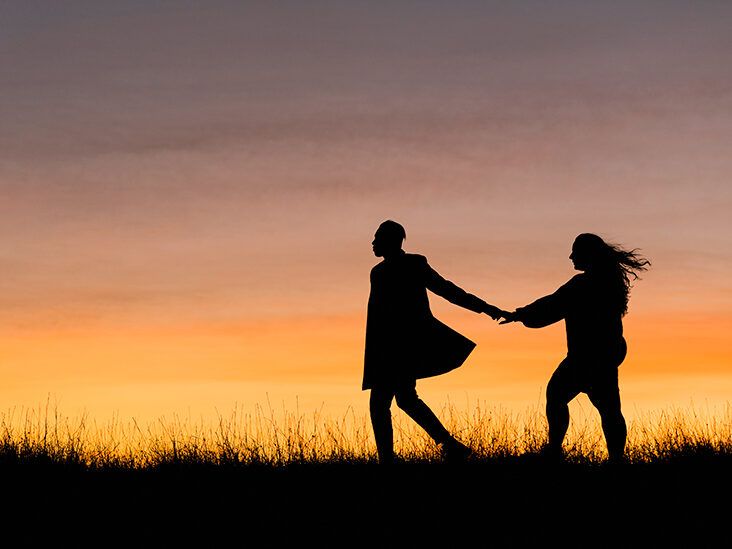 two friends holding hands silhouette