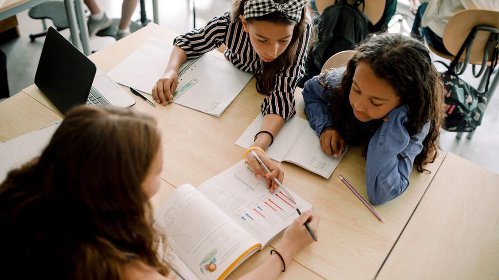 High angle view of girl students studying in classroom