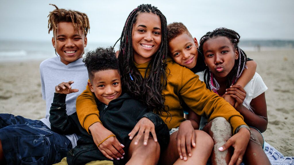 Mom with four kids at beach