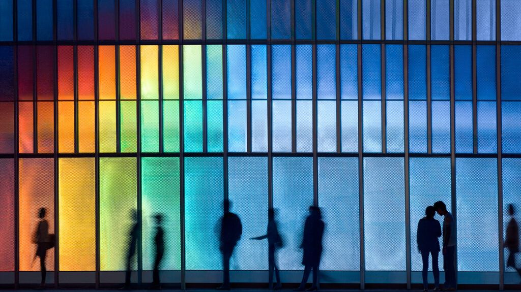 Several people walking in front of panes of glass reflecting rainbows to illustrate dissociative identity disorder
