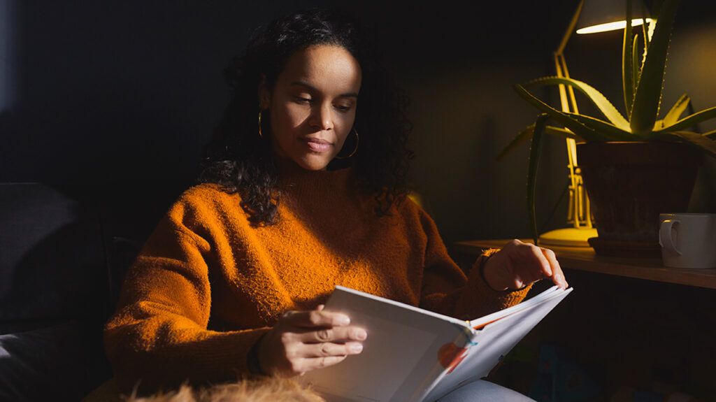 Woman sitting on a sofa couch reading