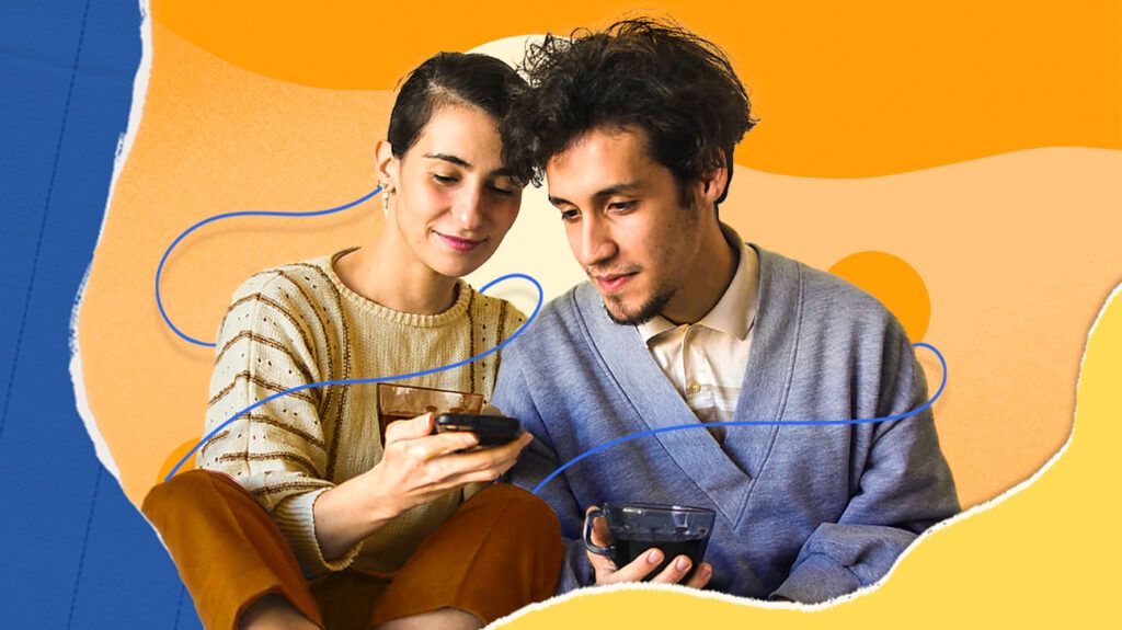 A young couple looking at a smartphone together