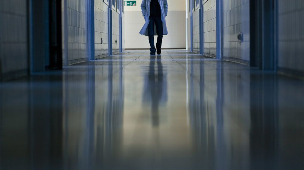 Doctor walking down hospital hallway