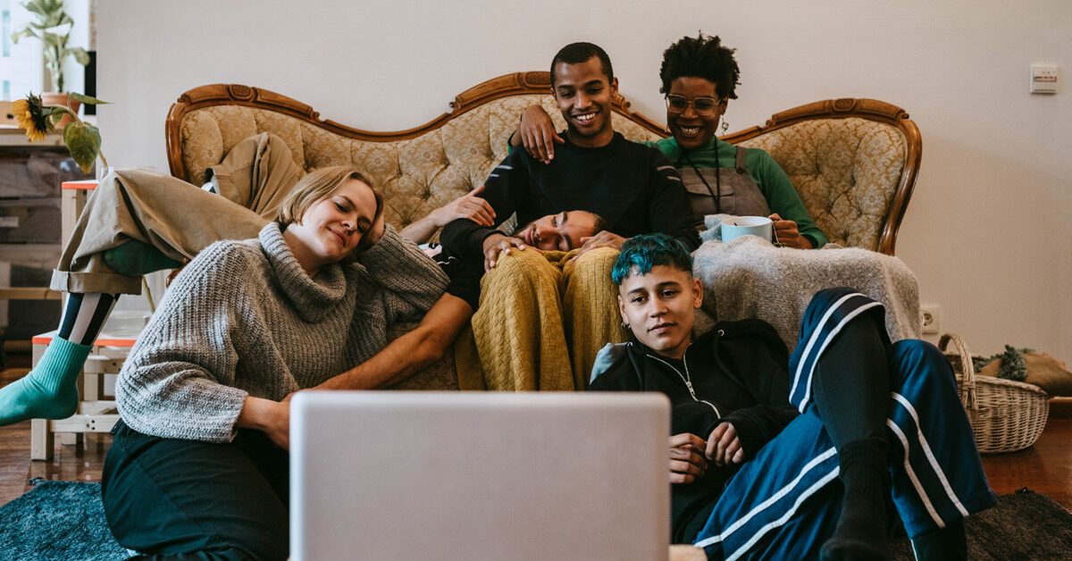 group of friends watching a movie at home 1200x628 facebook
