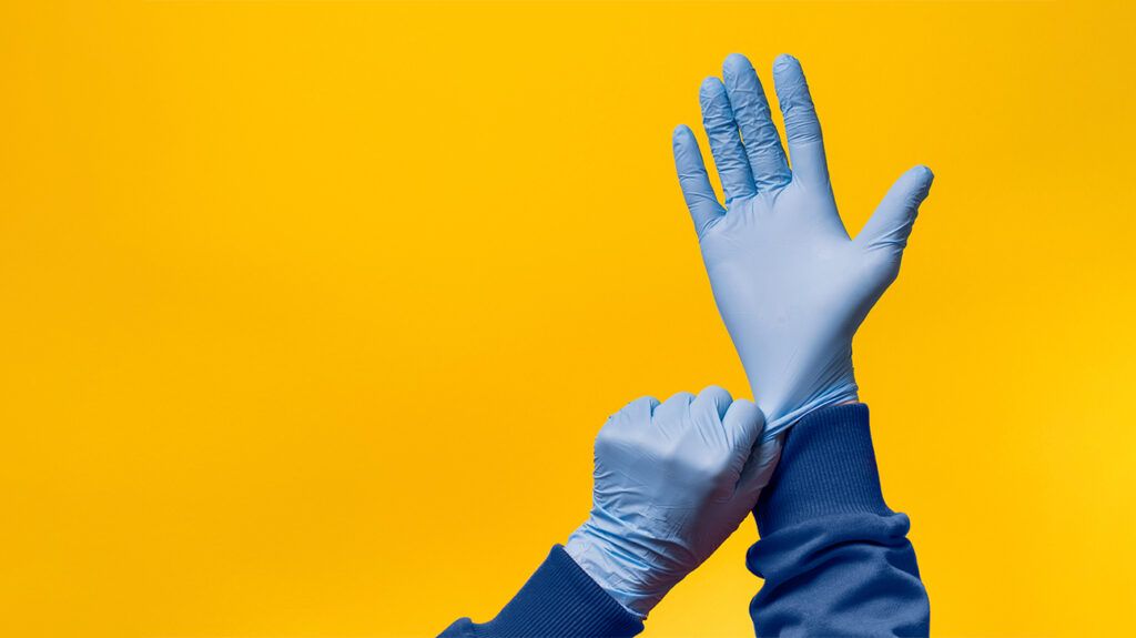 person with mysophobia or germophobia putting gloves on