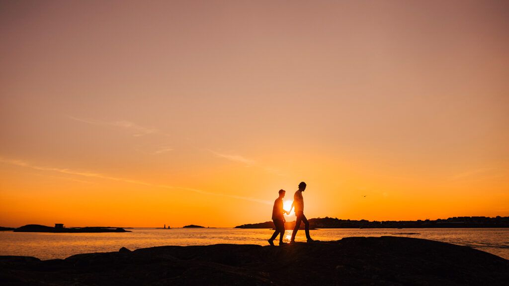 A couple walking the beach at sunset