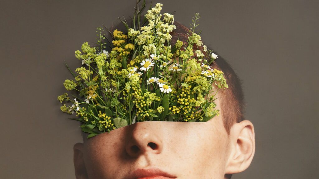 Portrait of man with flowers growing out of his eyes