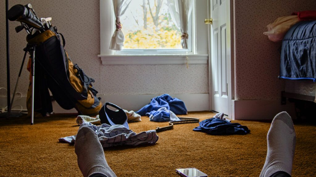 Person sitting in messy room, contemplating their depression