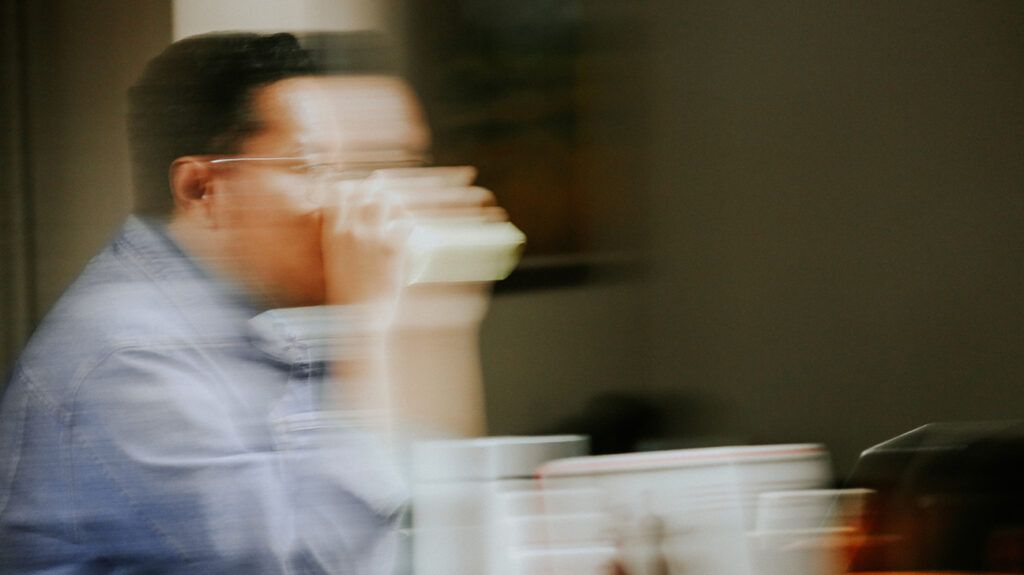 Man with anxiety walking, seemingly in a blur