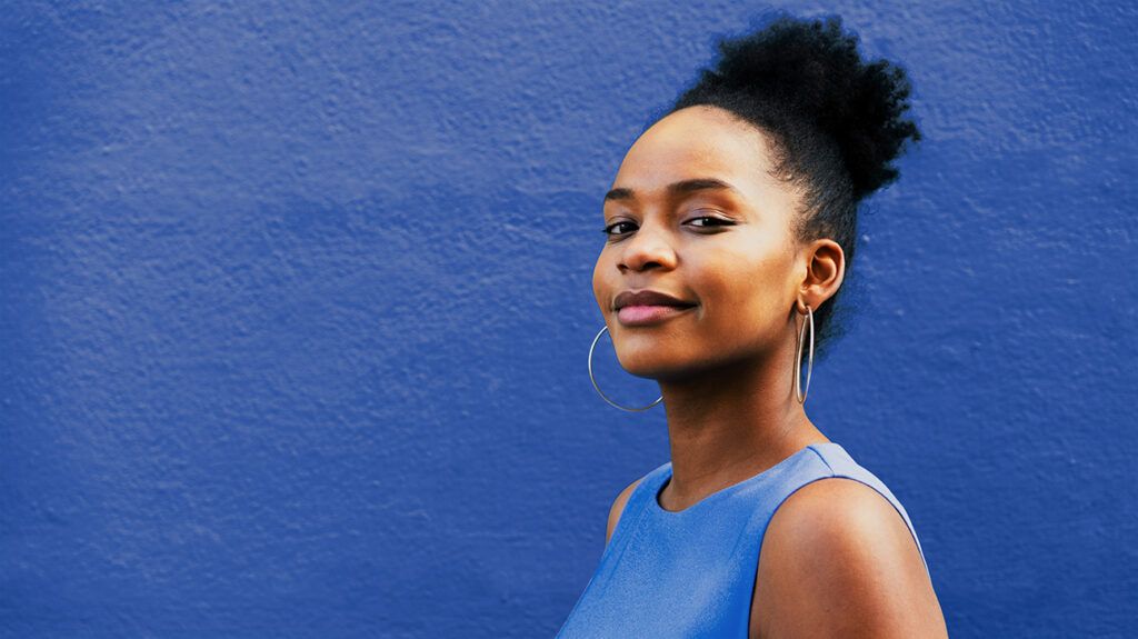 Portrait of smiling Black woman in blue