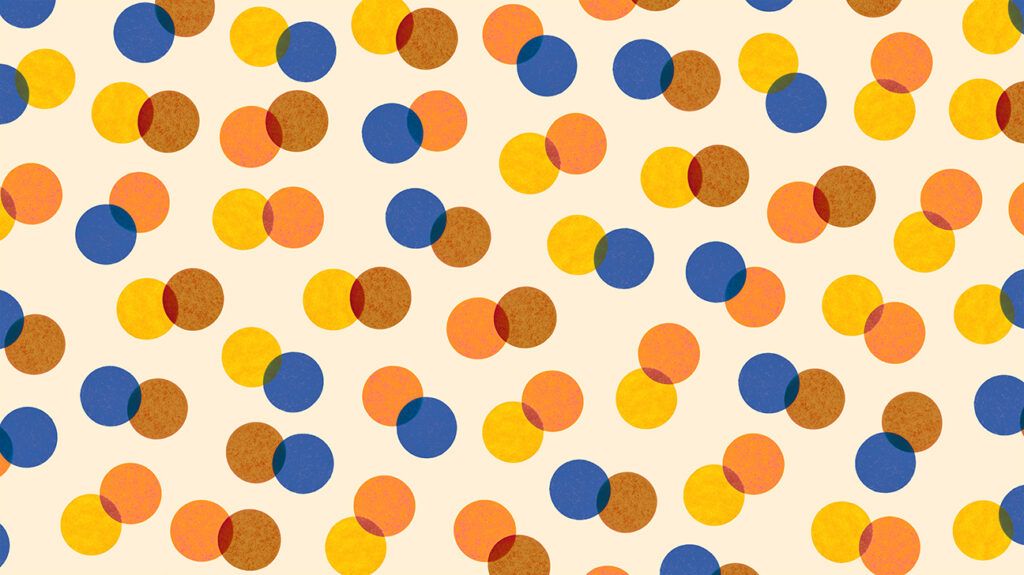 Colorful spots in yellow, blue, and orange on a back-lit paper