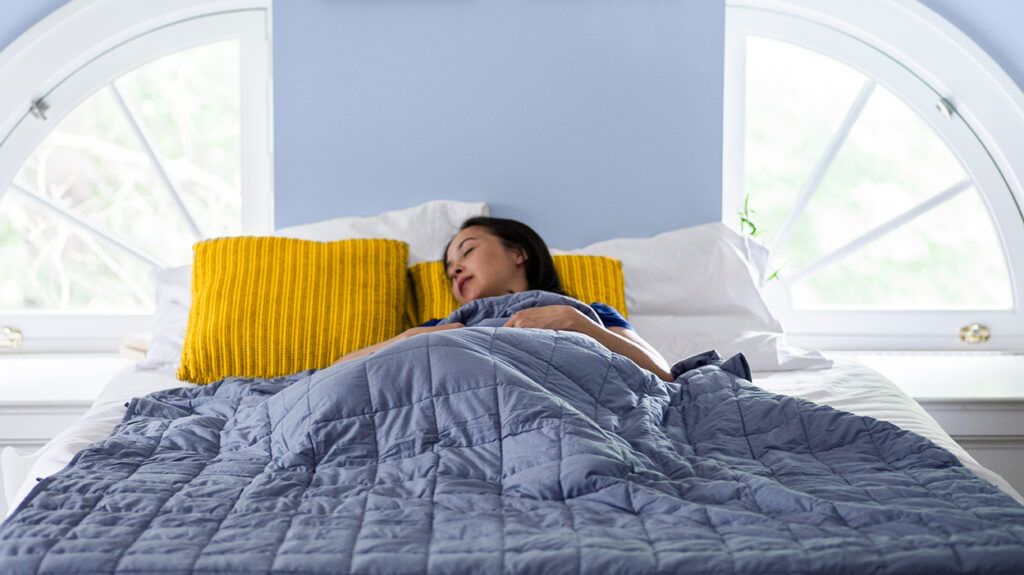 Woman sleeping with weighted blanket