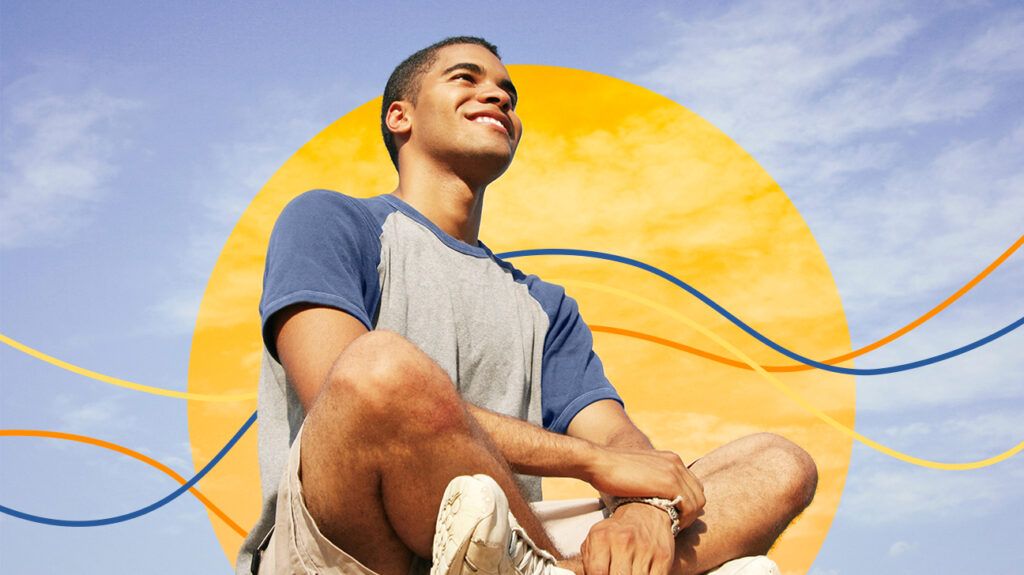 A teen sitting with sunshine on his face, symbolic of resilience