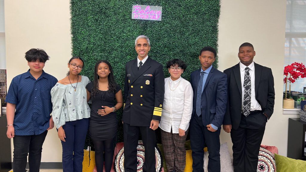 U.S. Surgeon General Dr. Vivek Murthy standing with a group of middle school students