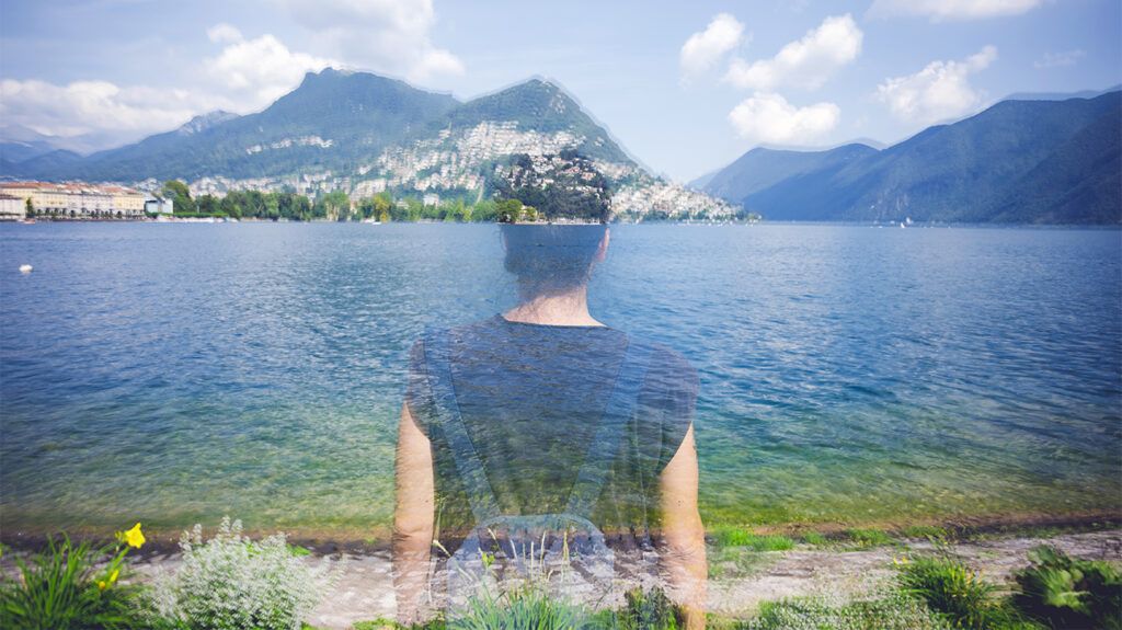 Person standing in front of a lake