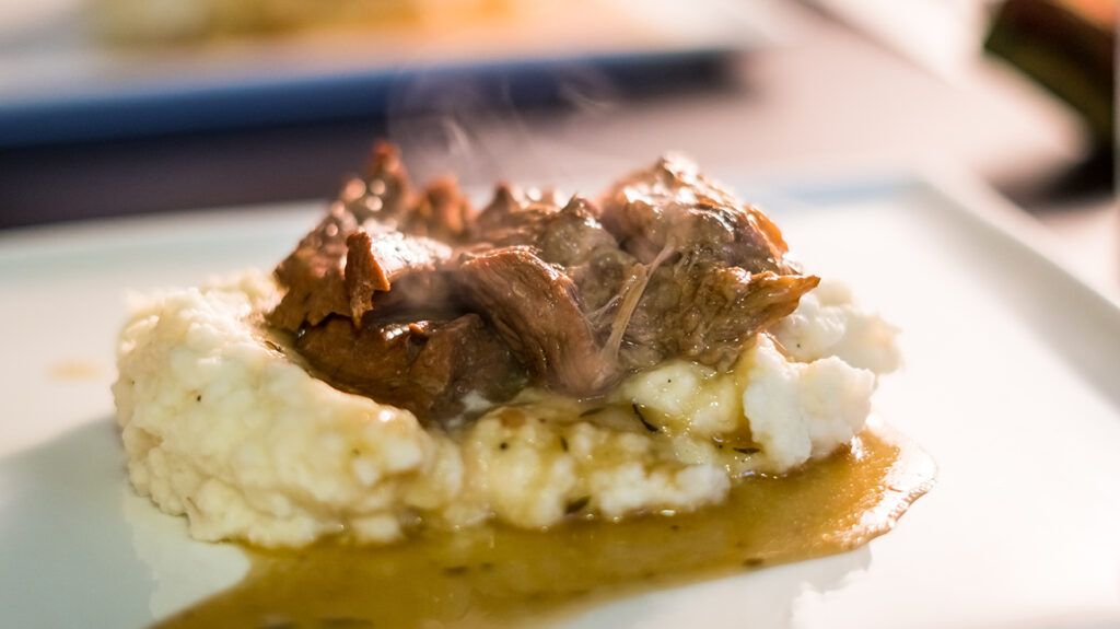 beef pot roast and gravy over mashed potatoes