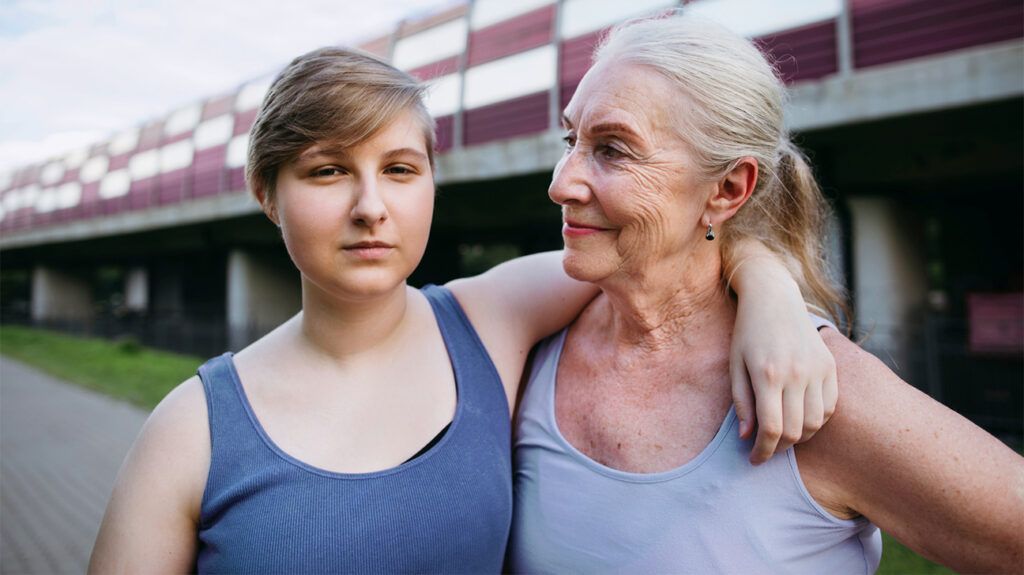 Mother and daughter with arm over shoulder