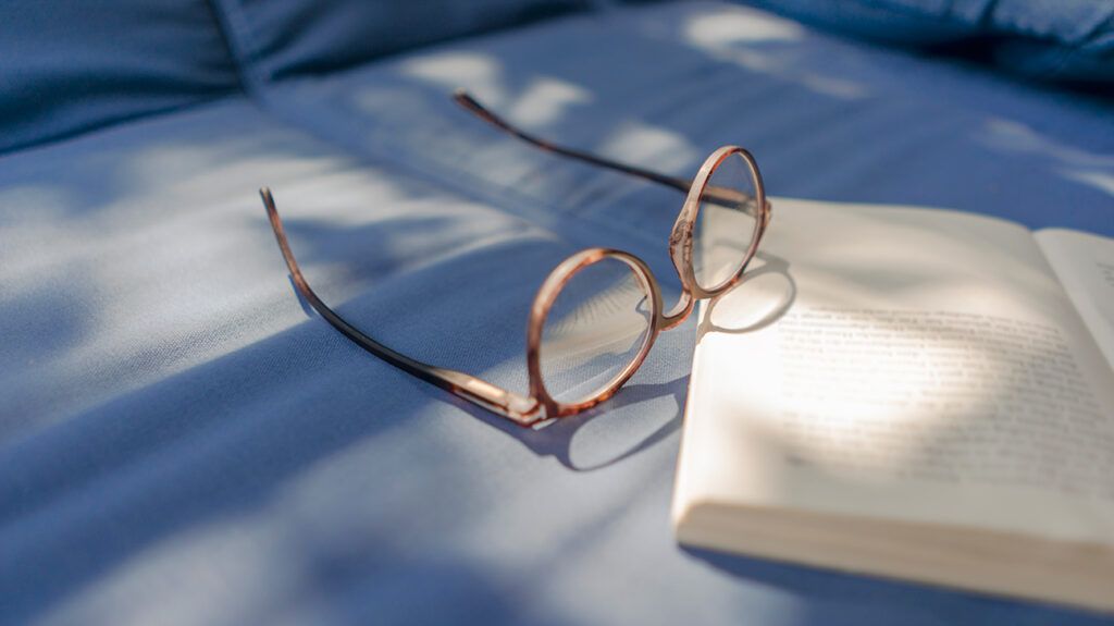 Eyeglasses lying on book
