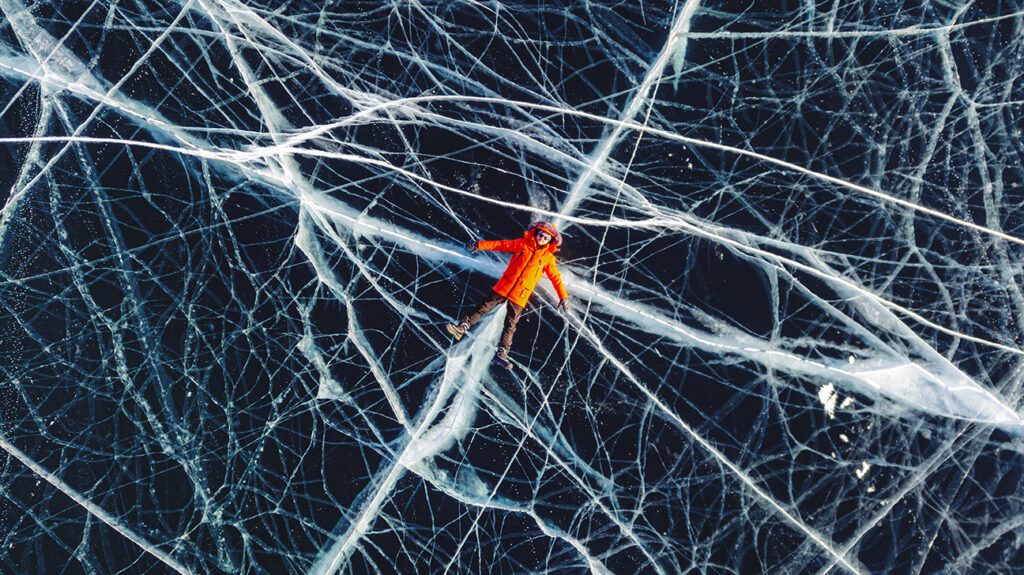 Person lying still on icy lake, symbolic of adhd paralysis