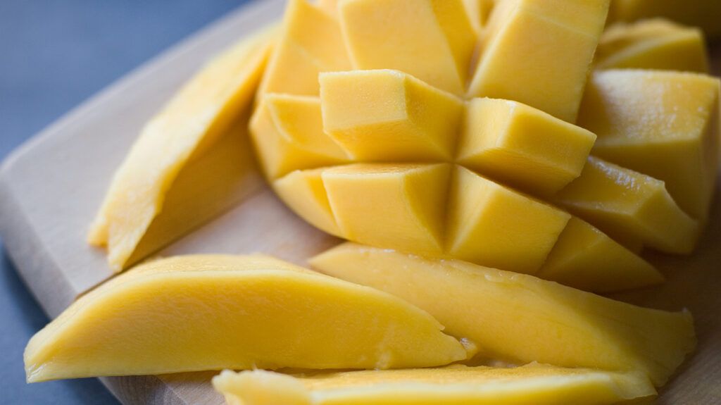 close up of peeled and sliced mango fruit