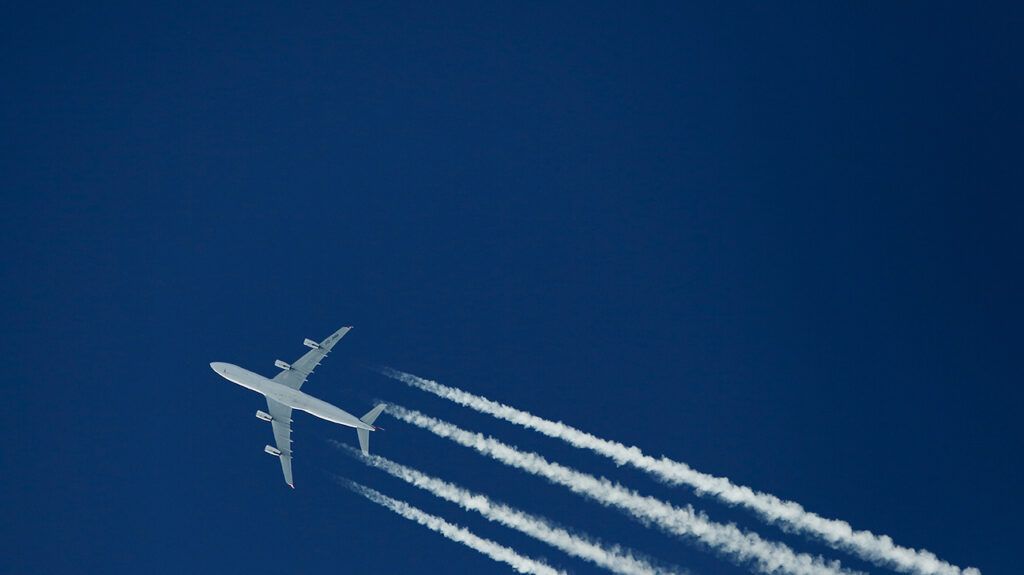 An airplane flying in a blue sky